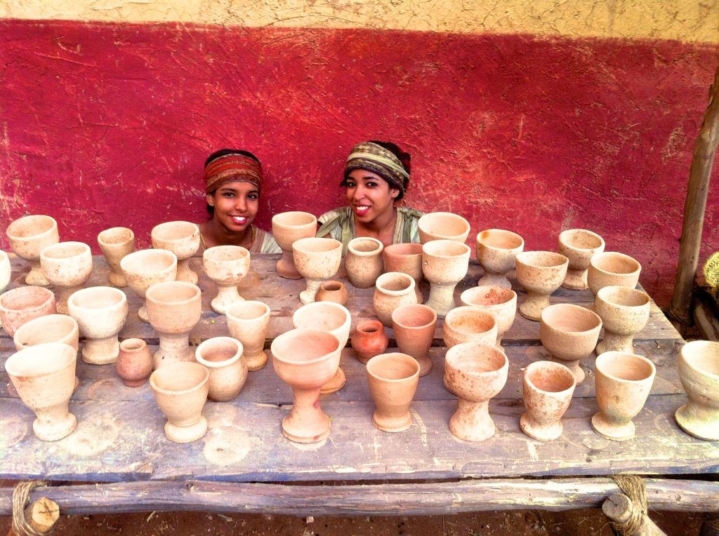 girls with clay cups